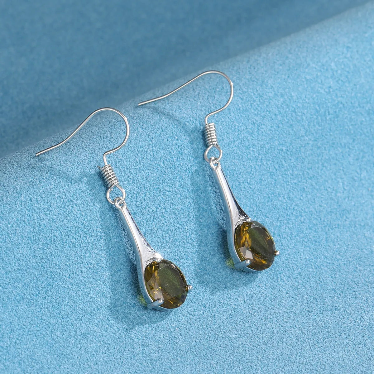 Olive green topaz water drop shaped earrings with electroplated finish and retro styling