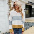 Women's short-length loose striped acrylic pullover sweater on a hanger.