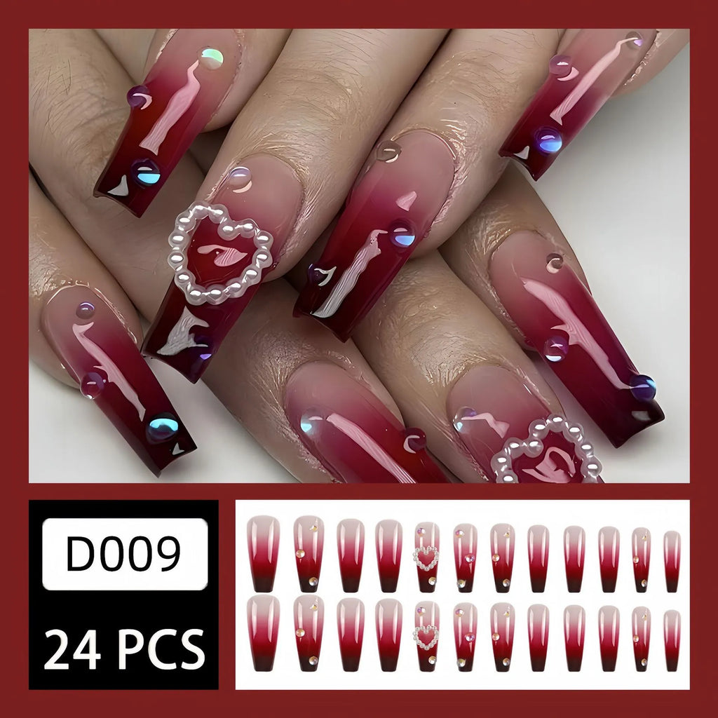 Wine red gradient false nail tips with plaid pattern and pearl heart accents in a long ballet shape.