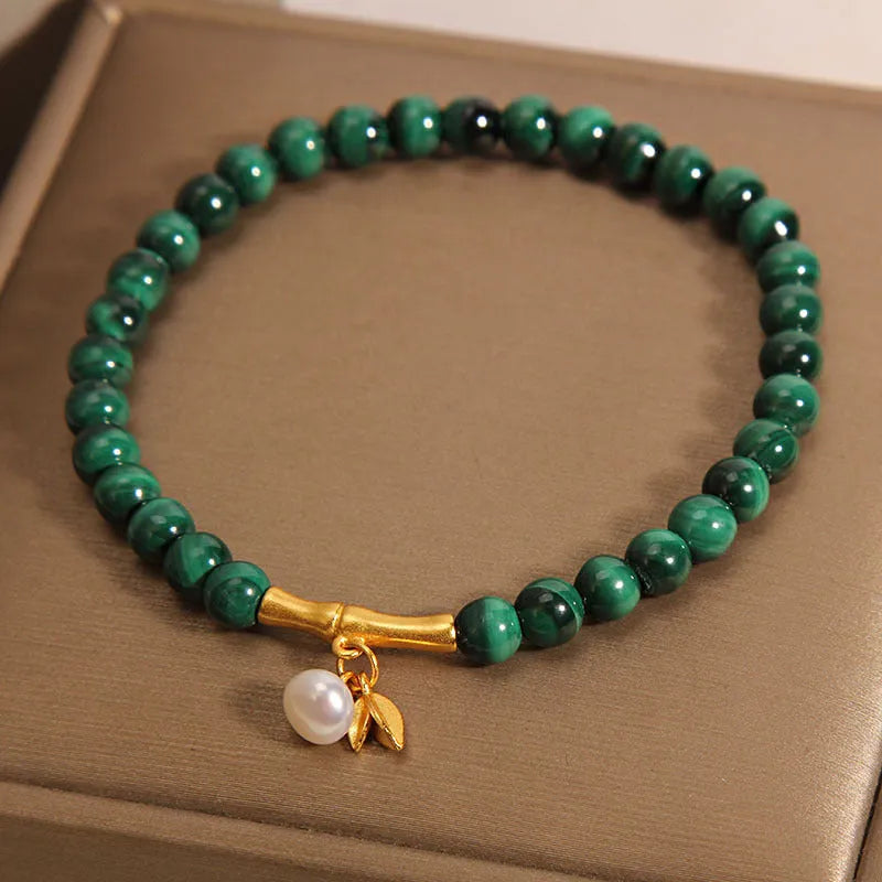Women's white crystal bracelet with a raised lucky bamboo design centrepiece.