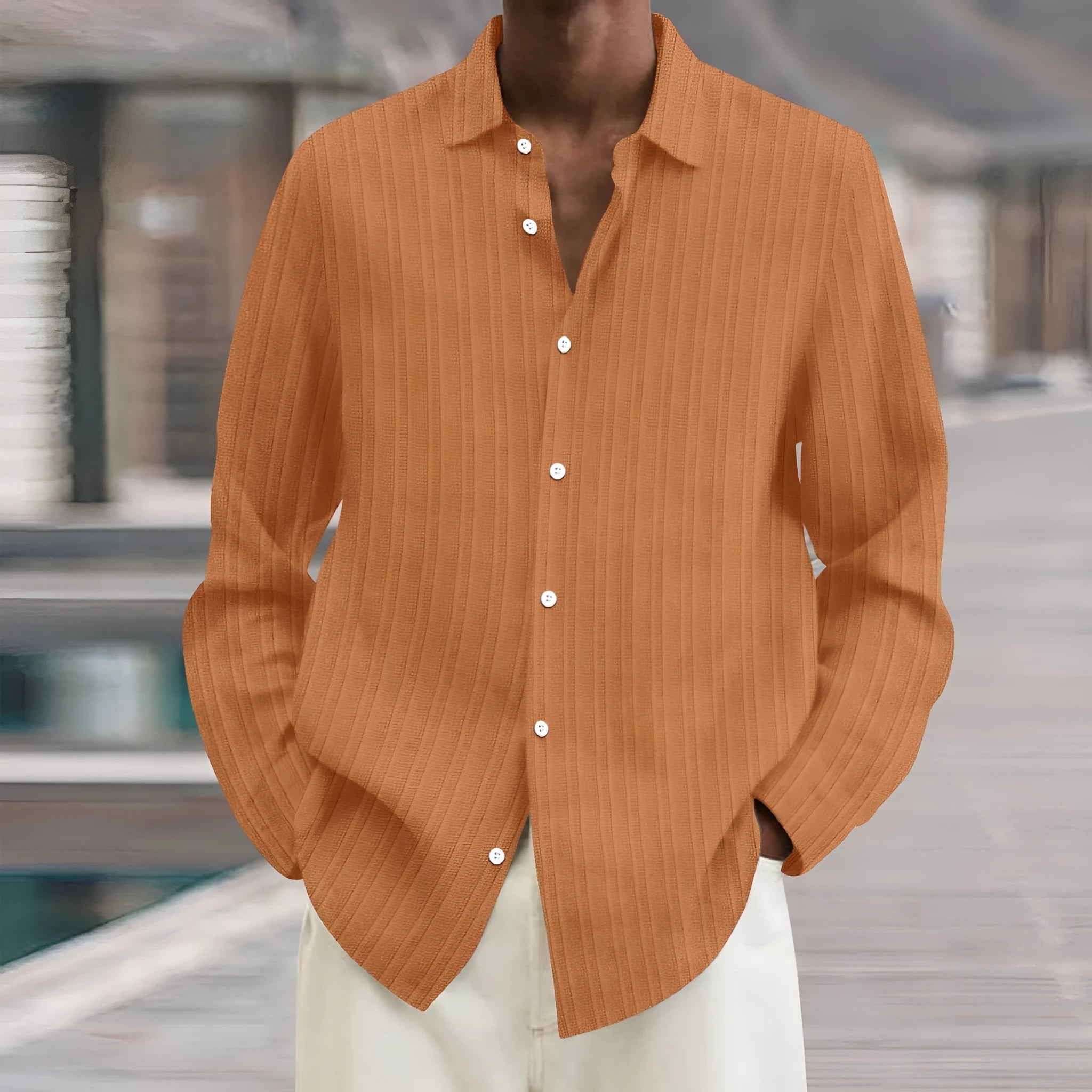 Man wearing a striped British style loose fit long sleeve cardigan shirt.