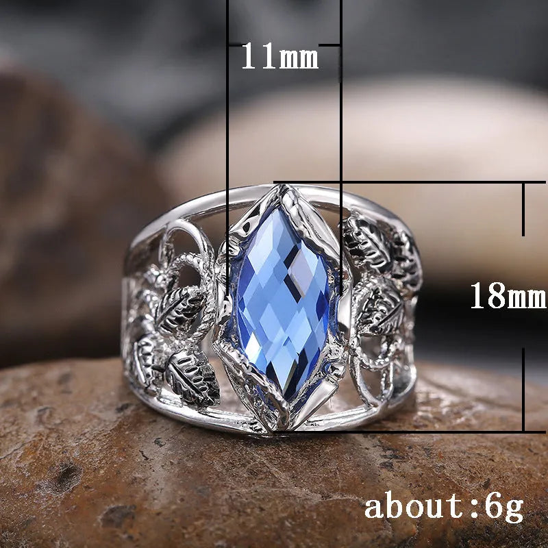 Blue horse eye shaped crystal ring for women on a hand, showing its geometric alloy design.