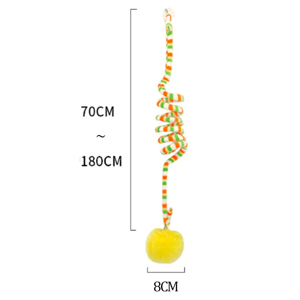 Spring cat toy with coloured inflatable ball and bell hanging from suction cup on glass door