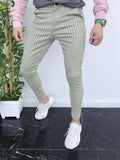 Man wearing slim-fit straight-leg plaid casual trousers in a striped pattern.