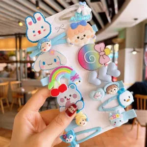14-piece set of colourful toddler hair clips with candy, fruit, rainbow, and butterfly designs on a white background.