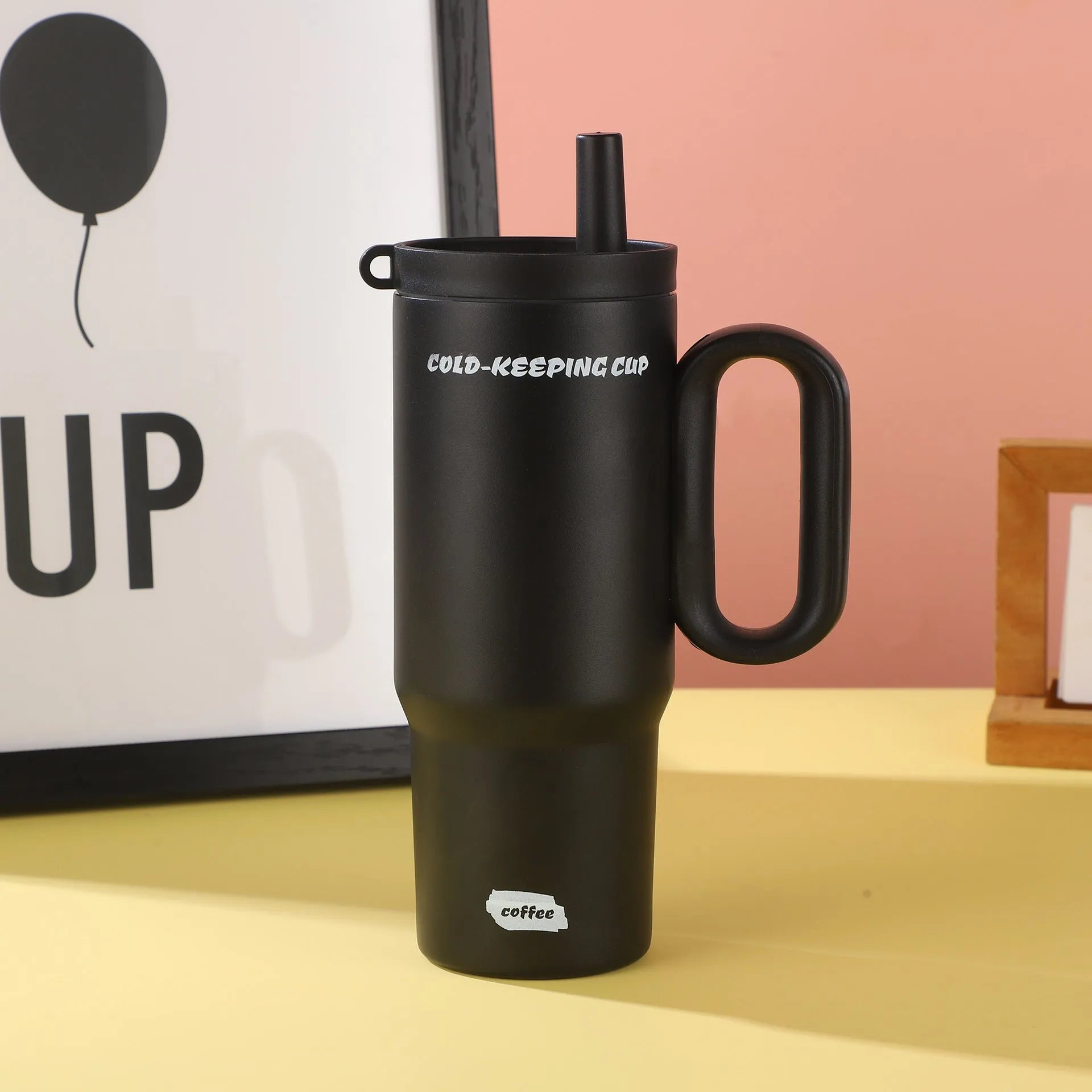 Insulated tumbler cup with a carrying handle and a straw, shown in one of five colour options.