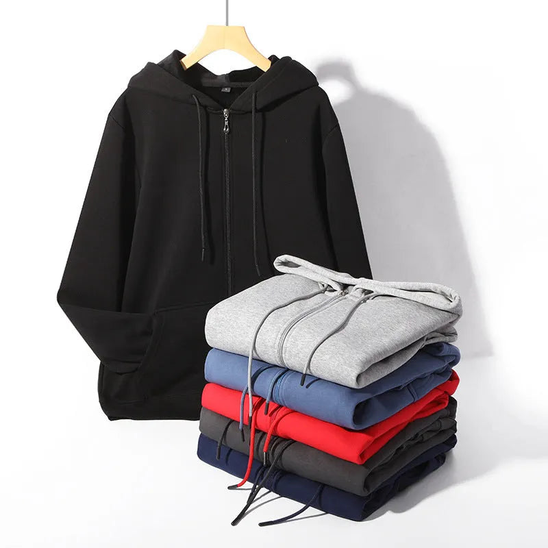 A plus size man wearing a heavy grey zip-up hooded cardigan sweater with side pockets.