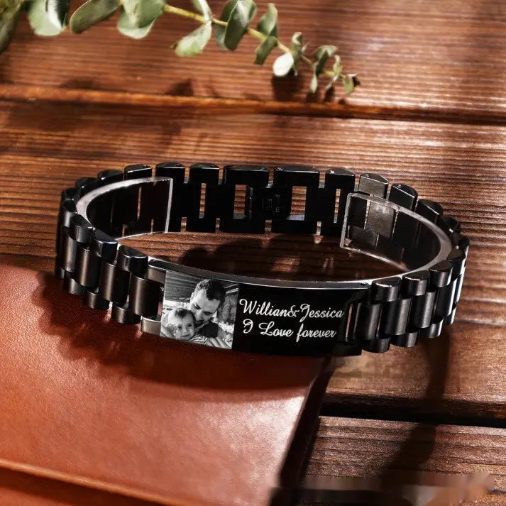 Men's stainless steel bracelet with curved heart piece featuring black electroplated lettering