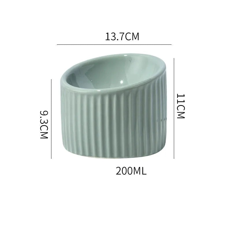 Ceramic elevated cat bowl in green, tilted design for anti-vomit, whisker-friendly feeding.