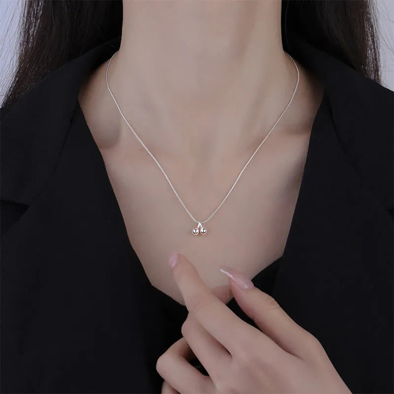 Silver cherry pendant necklace with adjustable snake bone chain on a 21cm to 50cm range.