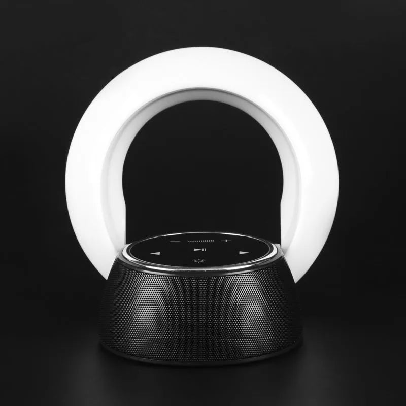 Creative folding Bluetooth speaker and LED desk lamp with touch controls on a desk.