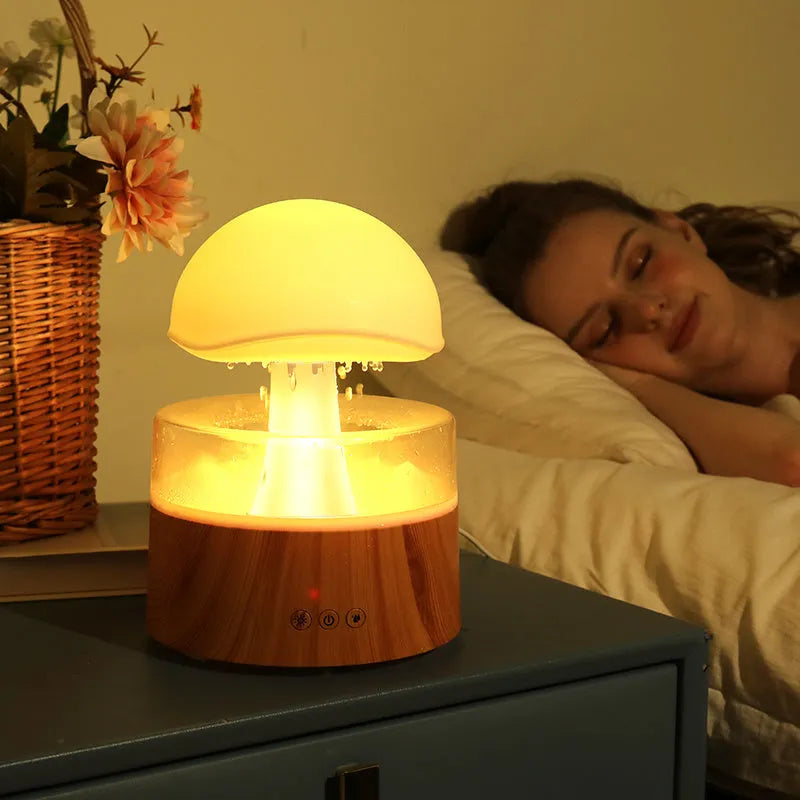 White cloud-shaped humidifier with LED lights and simulated rainfall, includes remote control