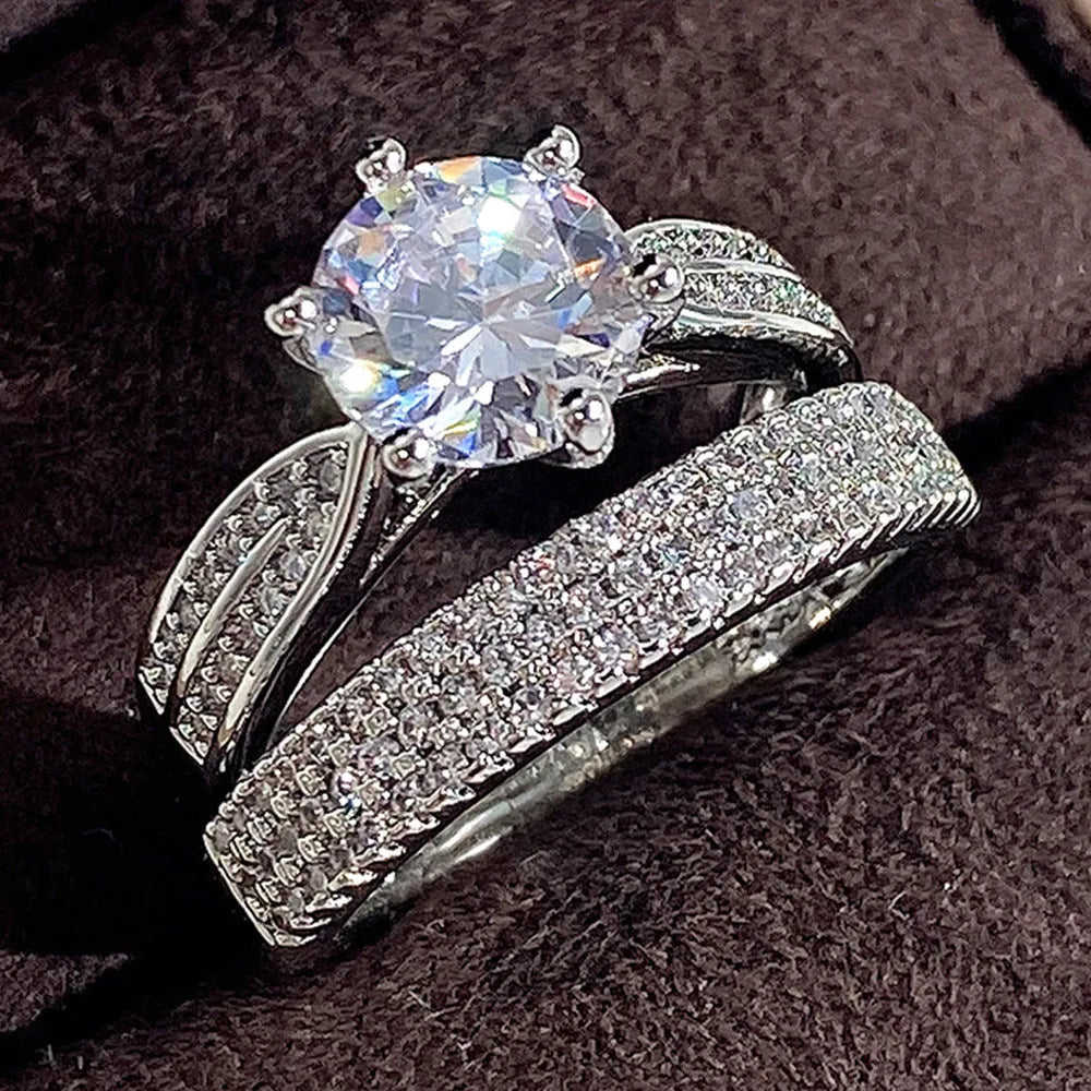 White gold colour alloy wedding ring bracelet with geometric round design showing seven available ring sizes
