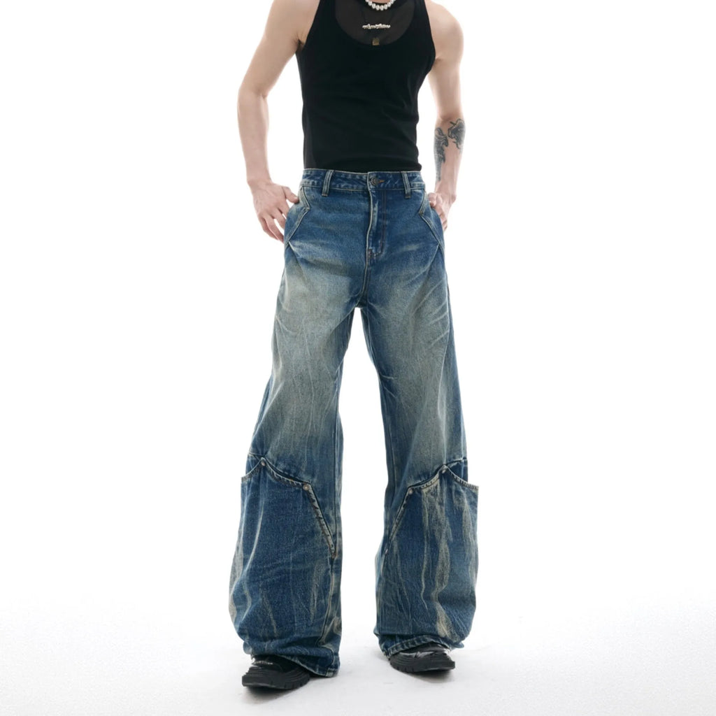 Men's verdant blue loose fit jeans with a retro washed burst pattern and curved knife design details.