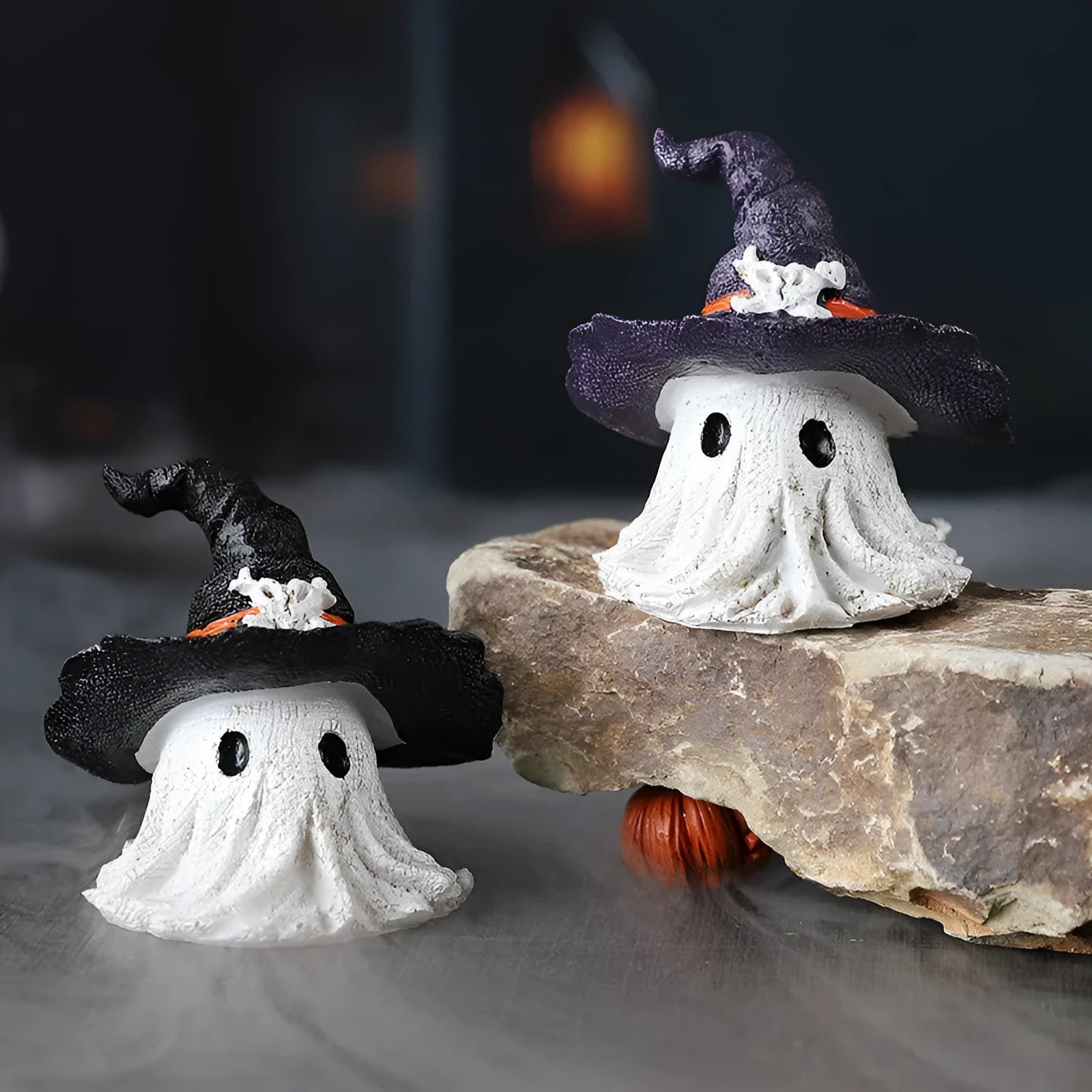 Small resin wizard hat ghost ornament in black or purple for holiday decoration.
