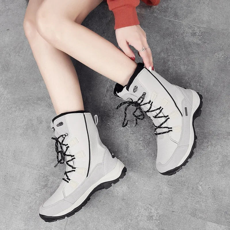 Women's black thermal snow boots with mid-calf height and round toe design