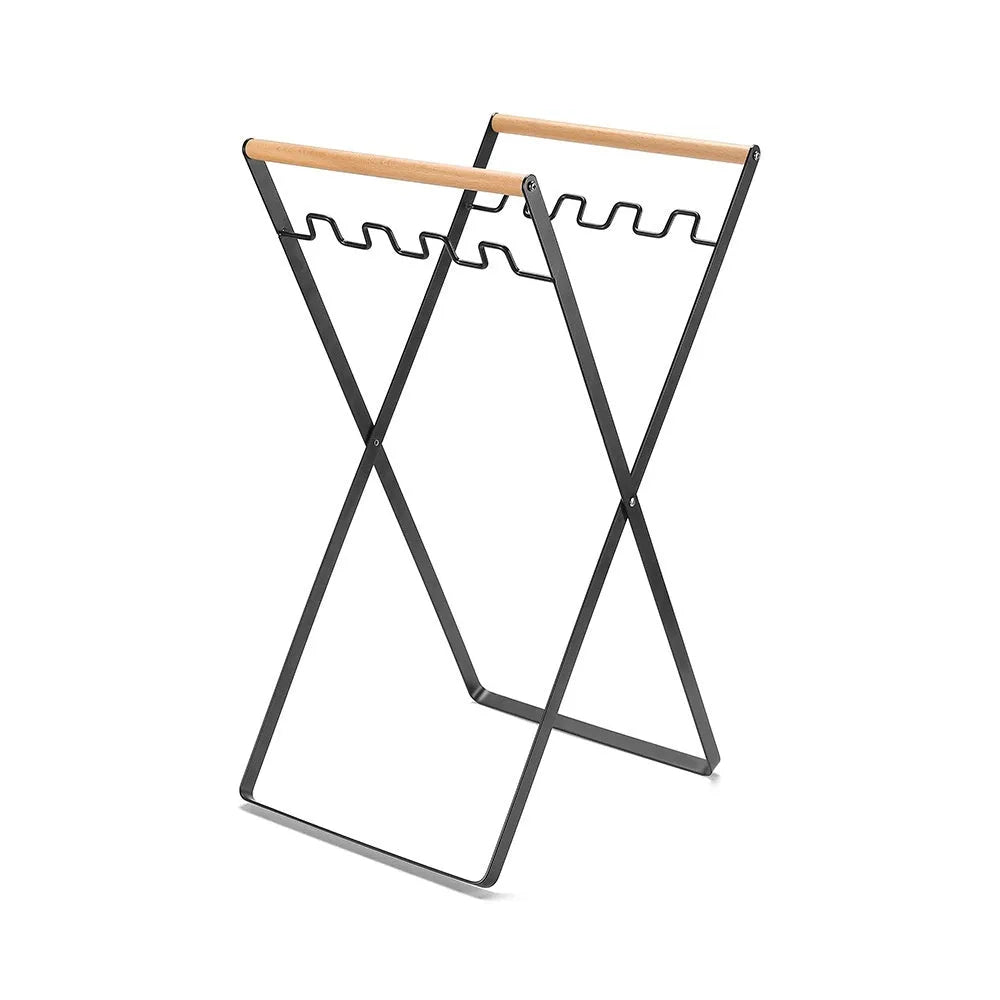 Iron and wooden folding trash storage rack for outdoor rubbish bags.