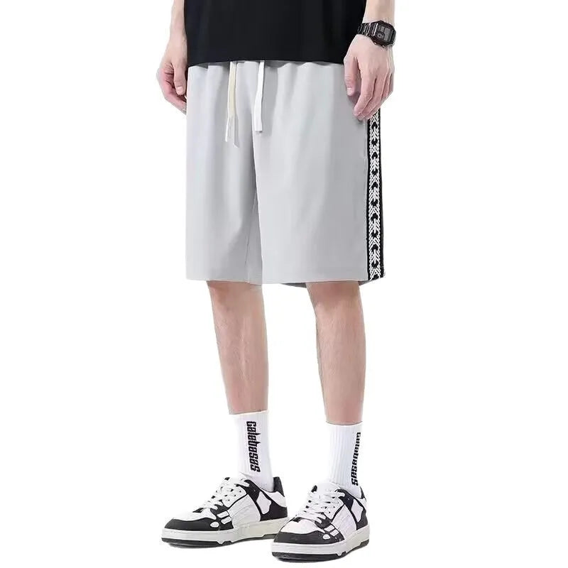 Men's black baggy track pants with loose-fit design and elastic waistband