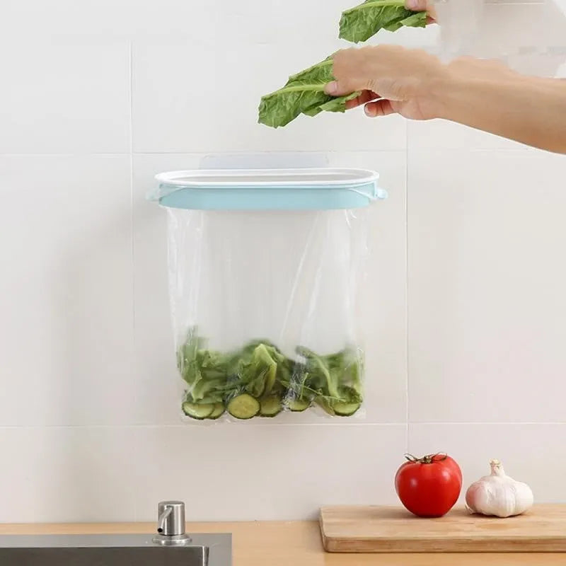 Blue plastic kitchen garbage bag storage rack mounted on cupboard door holding roll-on bin liners