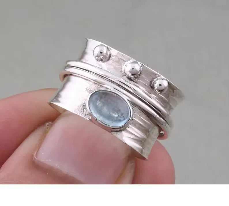 Handmade silver ring with natural aquamarine gemstone, retro geometric shape, on white background