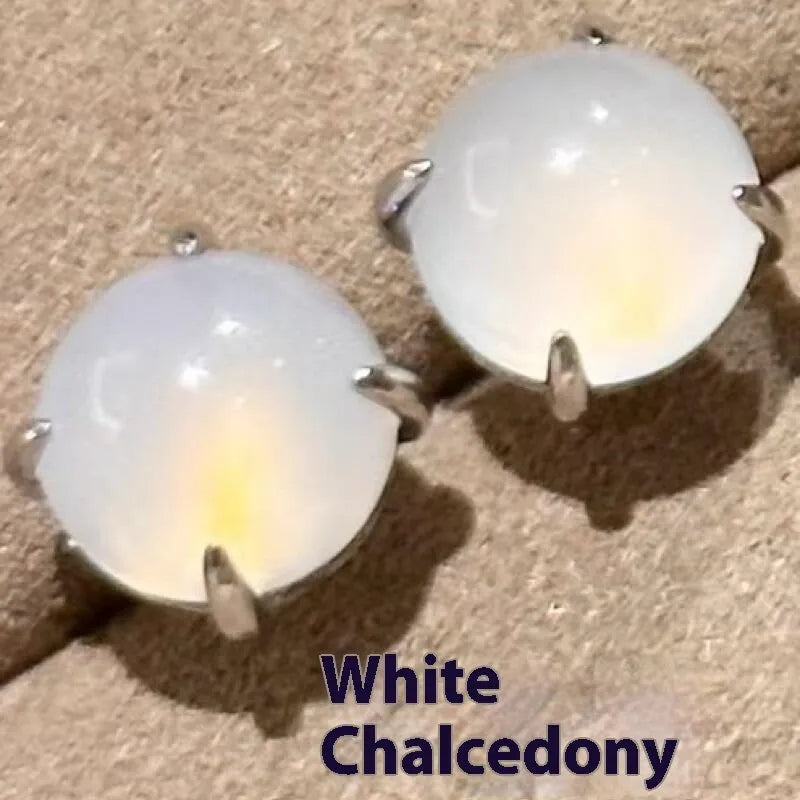 Round egg surface chalcedony stud earrings with four-claw copper settings in green, white, or pink.