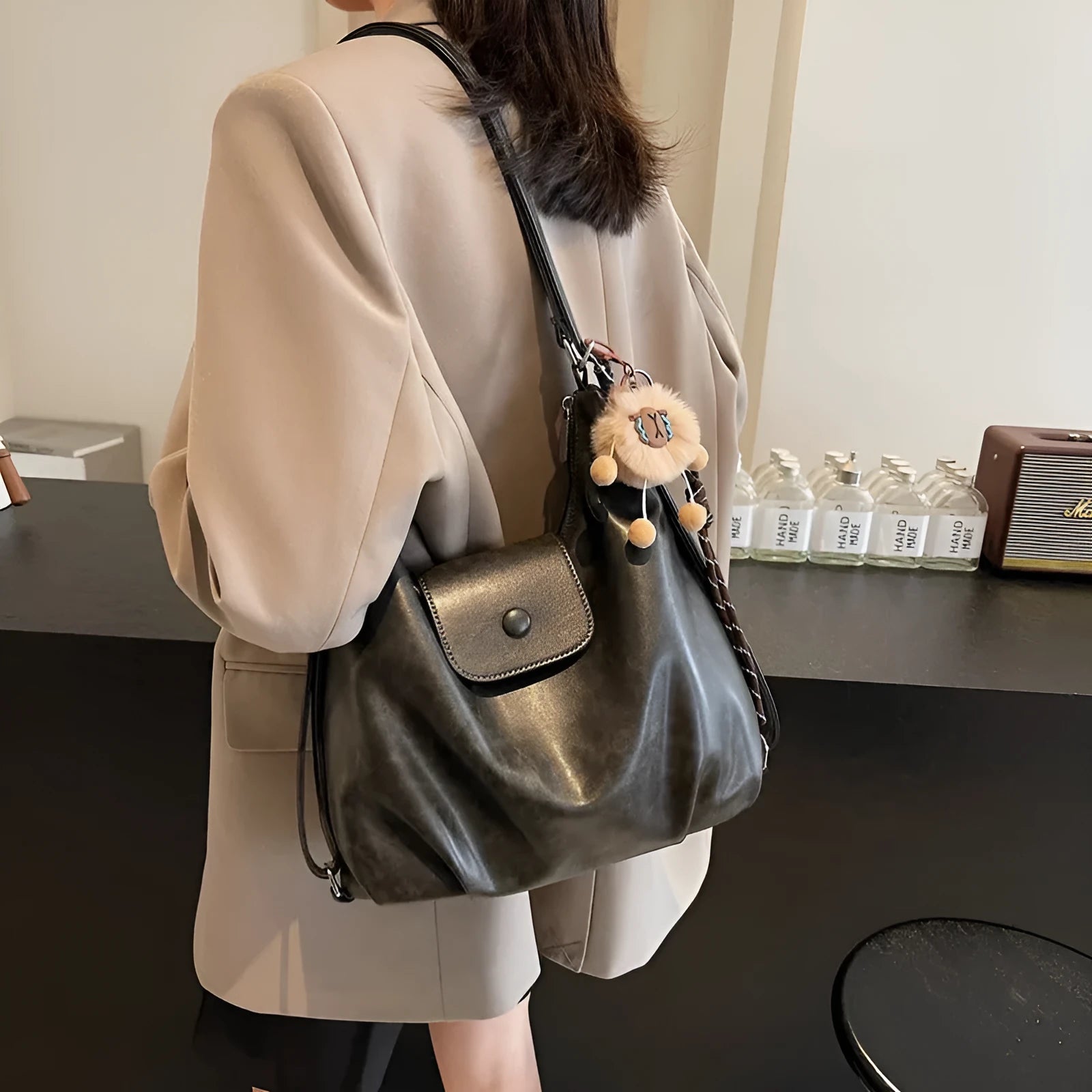 Textured PU leather shoulder bag in horizontal square shape with single strap and internal phone pocket