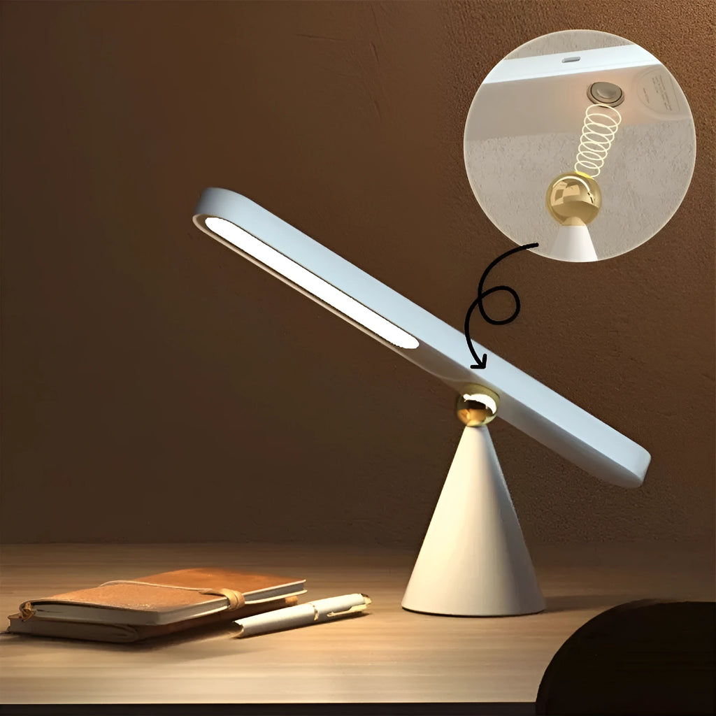 Geometric white desk lamp with magnetic base and USB cable on wooden table