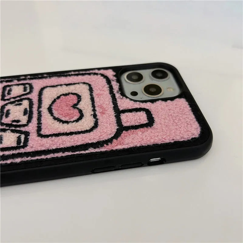 Pink iPhone back cover with a raised embroidered towel pattern design.
