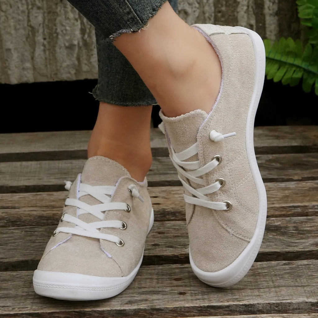 Women's creamy white low-top casual sneakers with fabric upper and rubber outsole on a neutral background