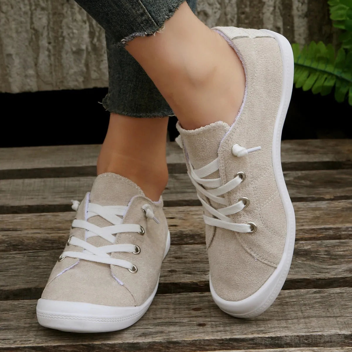 Women's creamy white low-top casual sneakers with fabric upper and rubber outsole on a neutral background