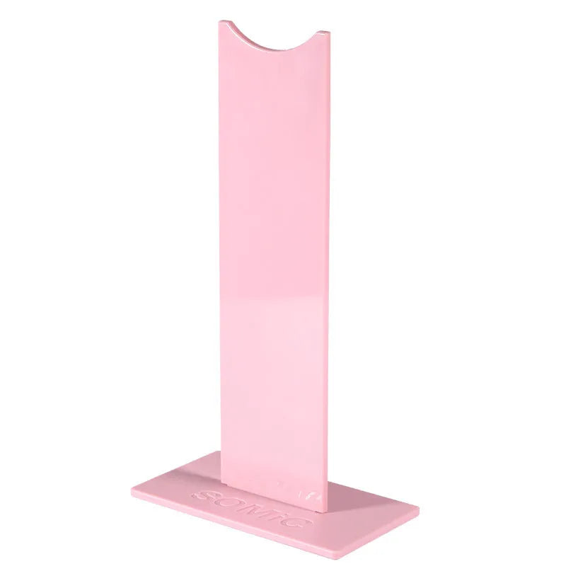 Pink and black detachable headphone stand on a desk with a non-slip silicone base.