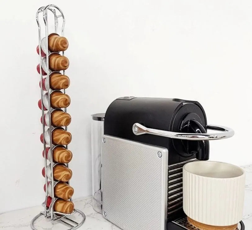 Black wrought iron coffee capsule storage rack holding pods on open shelves.