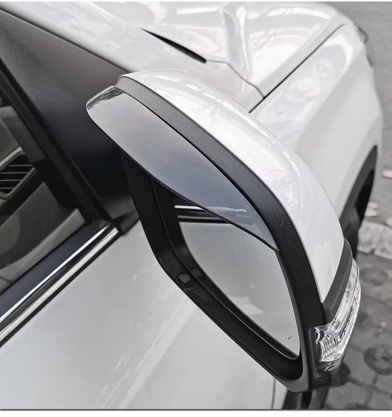 Pair of Mazda reversing mirror rain barrier strips in carbon fibre pattern on a Mazda CX5 side mirror