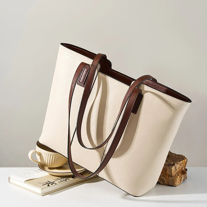 Women's black genuine leather crossbody commuter bag with square shape and multiple internal pockets.
