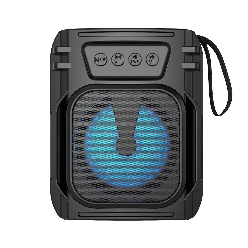 Compact portable Bluetooth speaker with USB charging cable on desktop