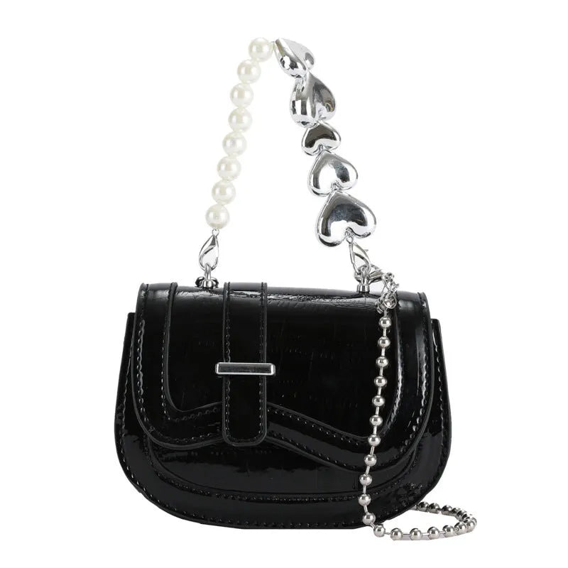Silver laser pearl finish women's crossbody mini saddle tote bag with single shoulder strap.