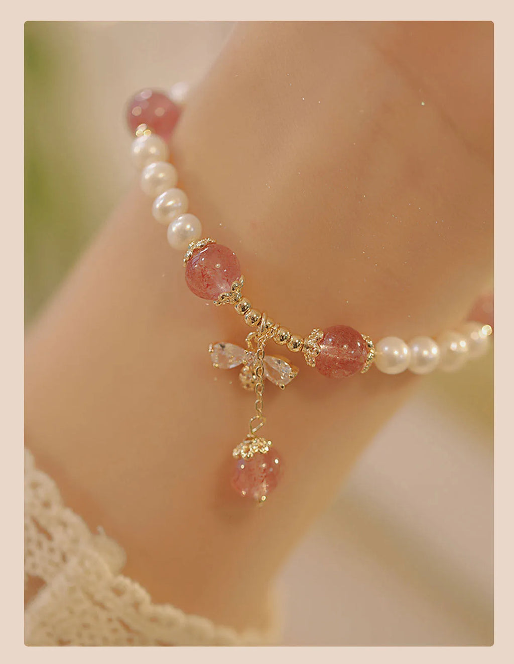 Women's strawberry quartz crystal bracelet with bow clasp closure on wrist