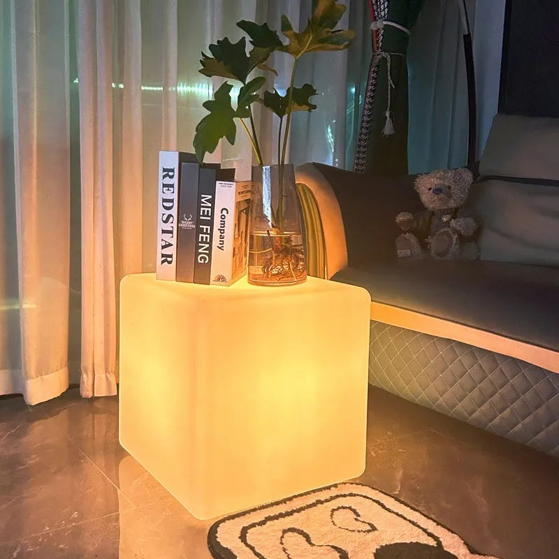 White square LED cube garden light stool with modern design, shown outdoors.
