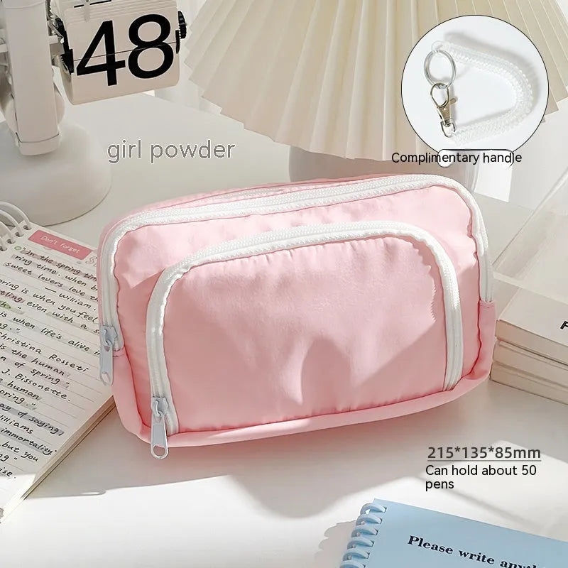 Double layer high-capacity pencil case in solid colour with gift handle, shown open to reveal two compartments.