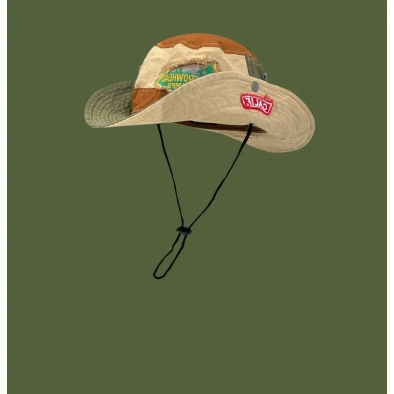 Army green foldable cotton fisherman hat with hand-painted patchwork design and flat top crown.