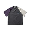Dark grey loose fit T-shirt with contrasting colour raglan short sleeves on a hanger