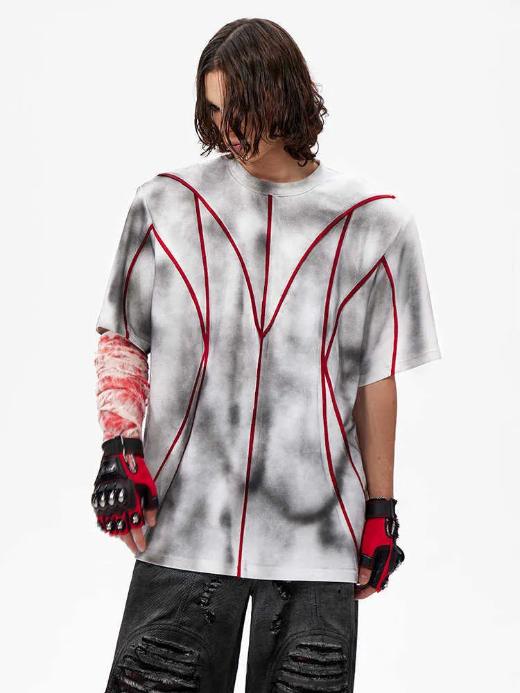 Men's grey T-shirt with padded shoulders and raised line patchwork detailing on the front.