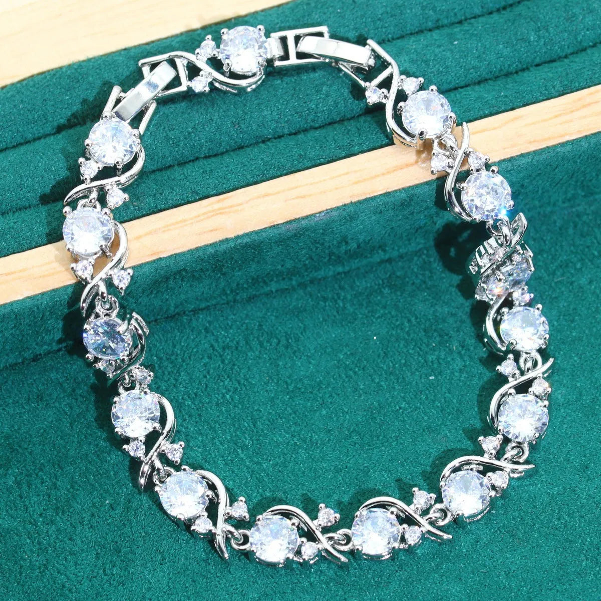 Four-piece bridal jewellery set showing necklace, bracelet, earrings, and ring with water wave chain