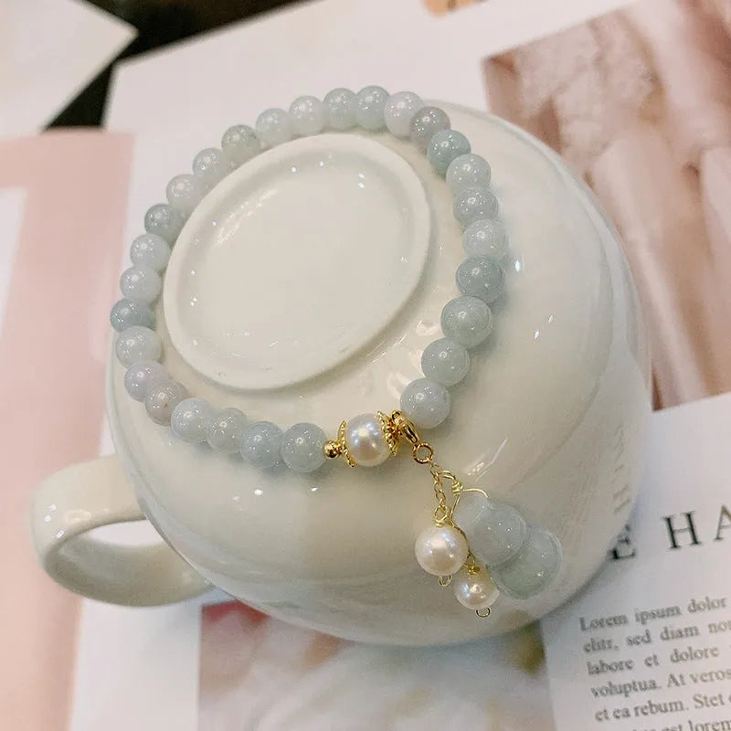 Close-up of a natural emerald jade bracelet with a handcrafted gourd design in Chinese style.