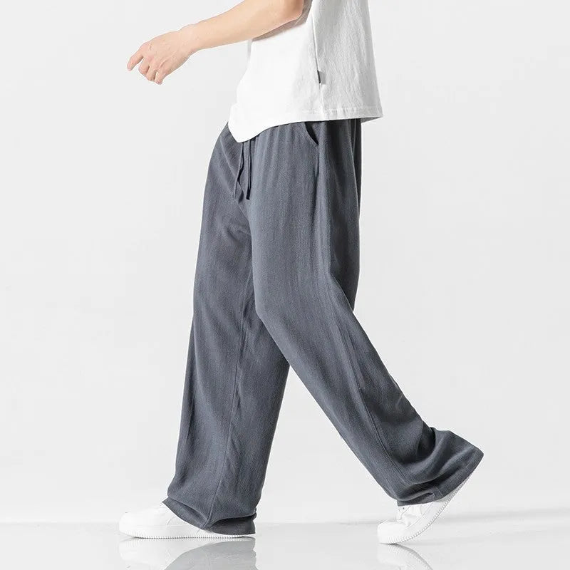 Men's beige bamboo fibre linen trousers with a straight leg, cropped length, and drawstring waist on a mid-rise.