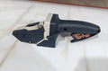 Blue aluminium alloy and plastic woodworking cutter with a built-in tape measure and safety blade.