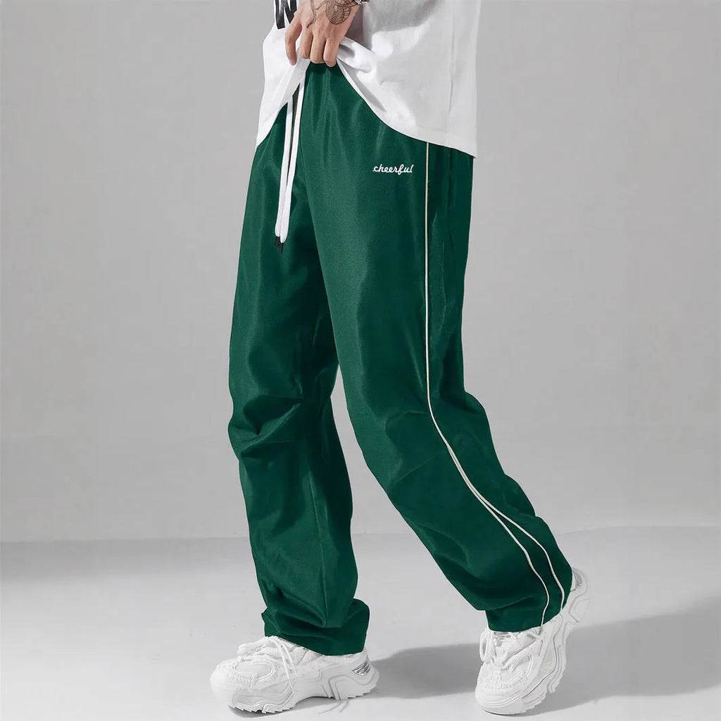 High street charging paratrooper pants for teenagers in straight leg style, available in multiple colours like black and dark green