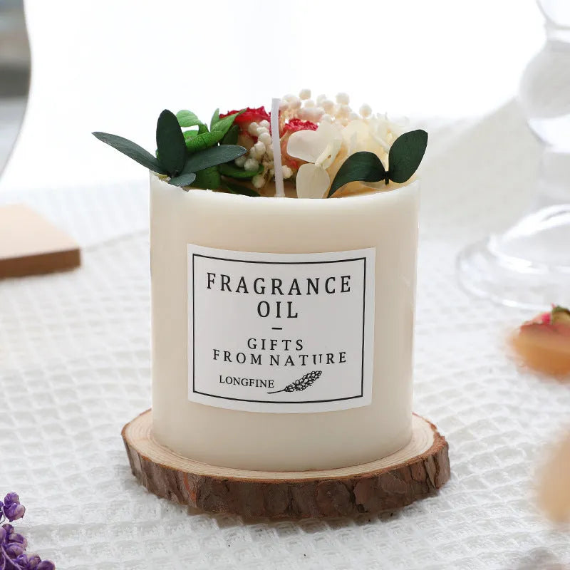 Decorative aromatherapy candle with dried flowers in wax, shown with optional wooden base and gift box.
