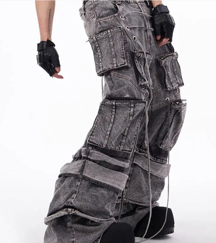 Grey cotton denim overalls with distressed finish and rope stitching on the legs.