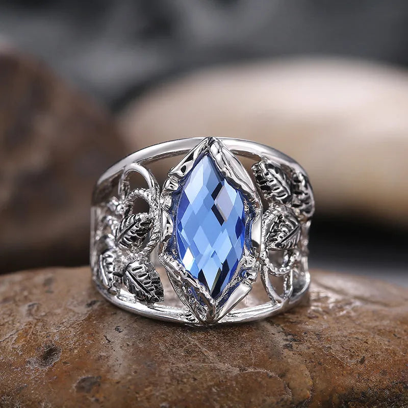 Blue horse eye shaped crystal ring for women on a hand, showing its geometric alloy design.